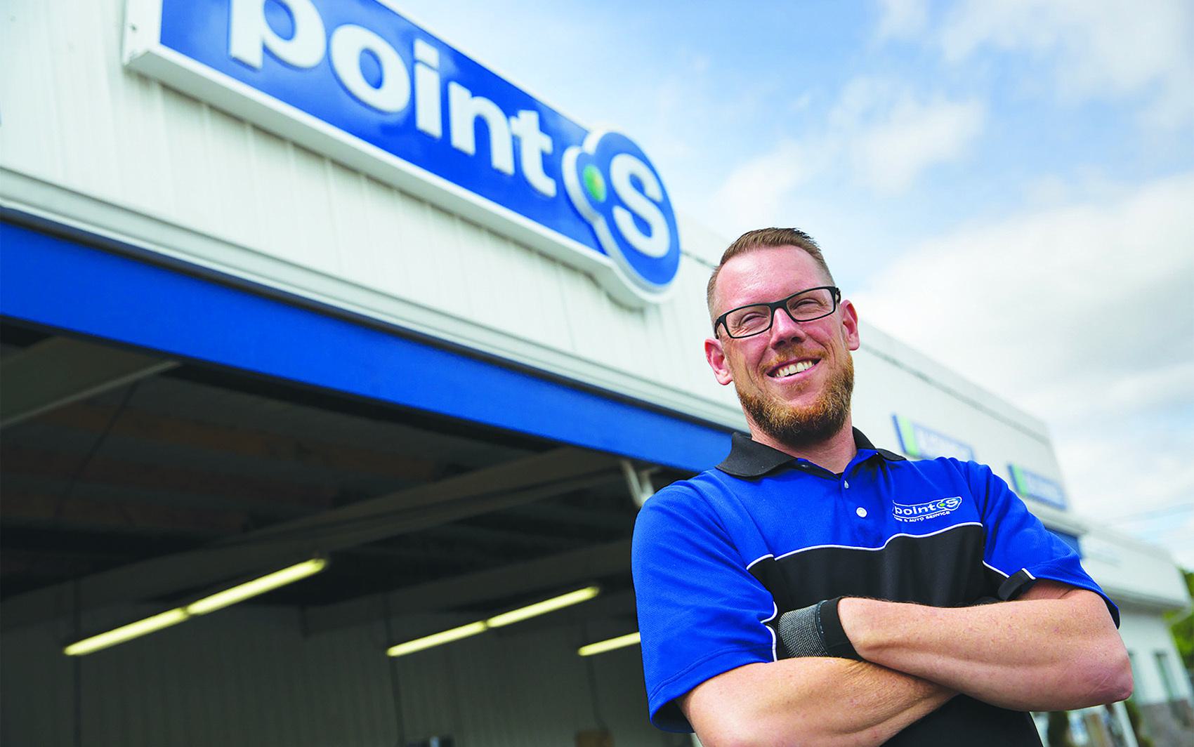 Ase certified person standing in front of auto service center