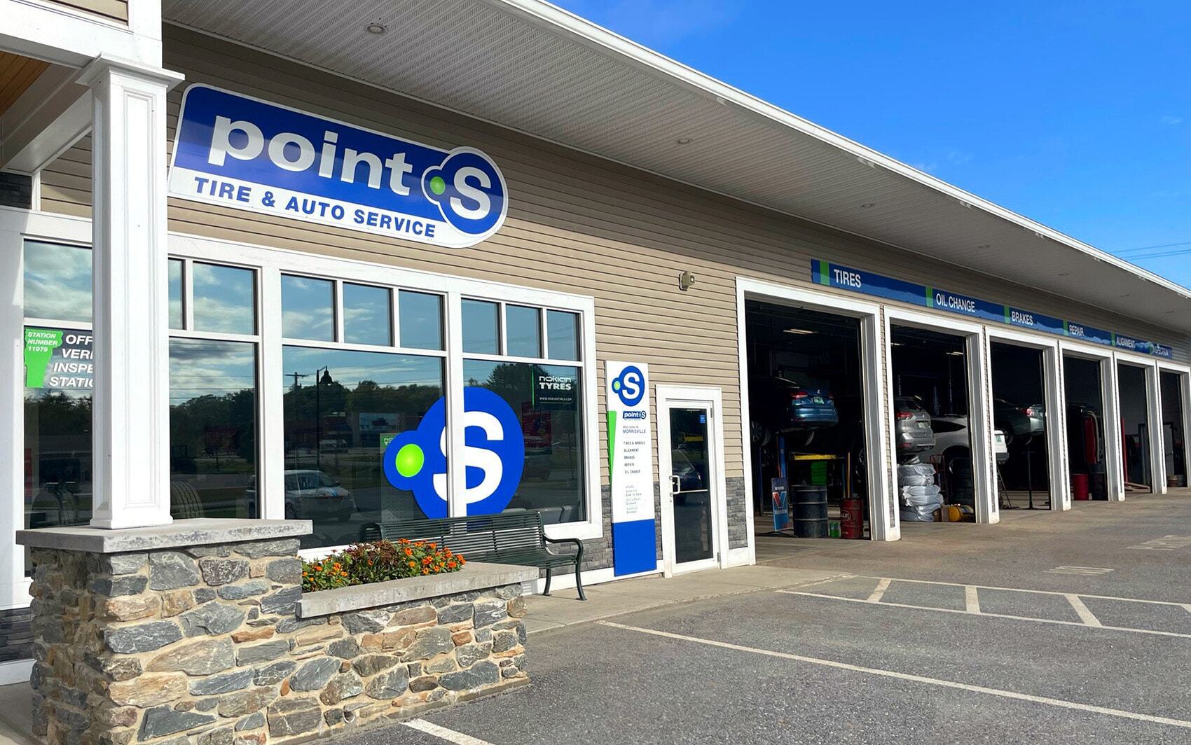 Tire repair exterior of auto service garage with multiple service bays